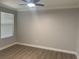 Bright bedroom with wood-look flooring, a ceiling fan, and a window offering natural light at 8101 W Flamingo Rd # 1102, Las Vegas, NV 89147