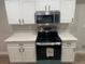 Kitchen boasts white cabinetry, quartz countertops, and stainless steel appliances with black hardware at 8101 W Flamingo Rd # 1102, Las Vegas, NV 89147