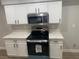 Kitchen highlights white cabinets, quartz countertops, and stainless steel oven and microwave at 8101 W Flamingo Rd # 1102, Las Vegas, NV 89147
