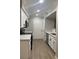 Modern kitchen featuring white cabinetry, black hardware, stainless steel appliances, and quartz countertops at 8101 W Flamingo Rd # 1102, Las Vegas, NV 89147