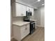 Bright kitchen showcases white cabinets with sleek black hardware and stainless steel microwave and oven at 8101 W Flamingo Rd # 1102, Las Vegas, NV 89147
