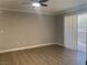 Empty living room showcasing wood flooring, white trim, and ceiling fan with light at 8101 W Flamingo Rd # 1102, Las Vegas, NV 89147