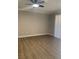 Empty living room showcasing wood flooring, white trim, and ceiling fan with light at 8101 W Flamingo Rd # 1102, Las Vegas, NV 89147
