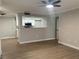 Living room with kitchen pass-through showcasing white kitchen cabinets and stainless appliances at 8101 W Flamingo Rd # 1102, Las Vegas, NV 89147
