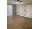 Bright living room featuring hardwood floors, ceiling fan, and natural light at 8101 W Flamingo Rd # 1102, Las Vegas, NV 89147