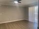 Empty living room showcasing wood flooring, white trim, and ceiling fan with light at 8101 W Flamingo Rd # 1102, Las Vegas, NV 89147