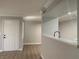 Open-concept layout with hardwood floors and kitchen pass-through at 8101 W Flamingo Rd # 1102, Las Vegas, NV 89147