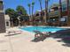 Community swimming pool with lounge chairs offers a place to relax in the sun at 8101 W Flamingo Rd # 1102, Las Vegas, NV 89147