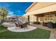 Well maintained backyard with covered patio, fire pit and outdoor furniture at 8149 Villa De La Playa St, Las Vegas, NV 89131