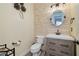 Half bath features stone accent wall, modern vanity and updated fixtures at 8149 Villa De La Playa St, Las Vegas, NV 89131