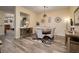 Elegant dining room features modern lighting, stylish decor, and wood floors at 8149 Villa De La Playa St, Las Vegas, NV 89131