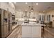 Modern kitchen with white cabinetry, stainless steel appliances, granite counters, and a breakfast bar at 8149 Villa De La Playa St, Las Vegas, NV 89131