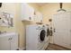 A bright and spacious laundry room with white cabinets and a sink at 8149 Villa De La Playa St, Las Vegas, NV 89131