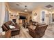 Inviting living room features a stone fireplace, leather seating, and modern lighting at 8149 Villa De La Playa St, Las Vegas, NV 89131