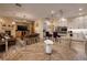 Open-concept living space with a stone fireplace, comfortable seating, wood floors, and eat-in kitchen at 8149 Villa De La Playa St, Las Vegas, NV 89131