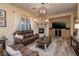 Comfortable living room with stone fireplace, wood floors, and ample natural light at 8149 Villa De La Playa St, Las Vegas, NV 89131