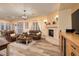 Spacious living room with stone fireplace, hardwood floors, and bright, natural lighting at 8149 Villa De La Playa St, Las Vegas, NV 89131