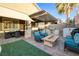 Outdoor kitchen featuring a built-in grill and covered patio with a fire pit at 8149 Villa De La Playa St, Las Vegas, NV 89131