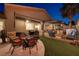 Outdoor living space featuring a covered patio, dining area, and grill, ideal for entertaining guests at 8149 Villa De La Playa St, Las Vegas, NV 89131