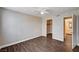 This bedroom features an adjoining closet, a door, and wood-like flooring at 8600 W Charleston Blvd # 1059, Las Vegas, NV 89117
