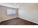 This bedroom features a ceiling fan, window with blinds, and wood-like flooring at 8600 W Charleston Blvd # 1059, Las Vegas, NV 89117