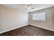 This bedroom features a ceiling fan, window with blinds, and wood-like flooring at 8600 W Charleston Blvd # 1059, Las Vegas, NV 89117