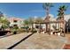 Common courtyard with a covered picnic area, seating, and mature landscaping, ideal for outdoor gatherings and relaxation at 8600 W Charleston Blvd # 1059, Las Vegas, NV 89117