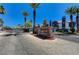 Community entrance with stone signage and palm trees on a sunny day at 8600 W Charleston Blvd # 1059, Las Vegas, NV 89117