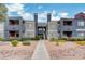 Apartment complex with desert landscaping, muted gray color palette with red accents at 8600 W Charleston Blvd # 1059, Las Vegas, NV 89117