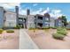 Apartment complex with desert landscaping, muted gray color palette with red accents at 8600 W Charleston Blvd # 1059, Las Vegas, NV 89117
