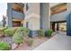 Multi-story building with grey exterior paint and well-maintained landscaping at 8600 W Charleston Blvd # 1059, Las Vegas, NV 89117