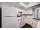 Cozy kitchen with white cabinets, a skylight and light countertops at 8600 W Charleston Blvd # 1059, Las Vegas, NV 89117