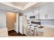 Bright kitchen with white cabinets, appliances, and a laundry nook at 8600 W Charleston Blvd # 1059, Las Vegas, NV 89117
