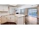 Bright, open-concept kitchen featuring white cabinets, quartz counters, and modern appliances overlooking the living area at 8600 W Charleston Blvd # 1059, Las Vegas, NV 89117