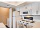 Bright kitchen with white cabinets, appliances, and a laundry nook at 8600 W Charleston Blvd # 1059, Las Vegas, NV 89117