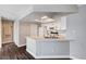 Updated kitchen featuring white cabinets, light quartz counters, and dark wood-look floors, and stainless appliances at 8600 W Charleston Blvd # 1059, Las Vegas, NV 89117