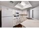 Cozy kitchen with white cabinets, a skylight and light countertops at 8600 W Charleston Blvd # 1059, Las Vegas, NV 89117