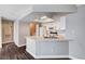 Updated kitchen featuring white cabinets, light quartz counters, and dark wood-look floors, and stainless appliances at 8600 W Charleston Blvd # 1059, Las Vegas, NV 89117