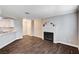 Spacious living room featuring a fireplace, hardwood floors, and a view of the kitchen at 8600 W Charleston Blvd # 1059, Las Vegas, NV 89117