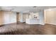 Open concept living room with view of kitchen, white cabinets, and wood floors at 8600 W Charleston Blvd # 1059, Las Vegas, NV 89117