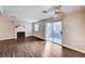 Large living room with fireplace, hardwood floors, and a sliding door to the patio at 8600 W Charleston Blvd # 1059, Las Vegas, NV 89117