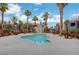 Community pool surrounded by palm trees and well-maintained landscaping, providing a relaxing oasis for residents at 8600 W Charleston Blvd # 1059, Las Vegas, NV 89117