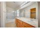 Bathroom featuring a double sink vanity, a shower and tub combo, and a large mirror at 8768 Tom Noon Ave # 101, Las Vegas, NV 89178