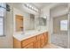 Bathroom featuring a double sink vanity, a large mirror, and a view to the bedroom at 8768 Tom Noon Ave # 101, Las Vegas, NV 89178