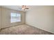 Bedroom with neutral carpet and a window that fills the room with natural light at 8768 Tom Noon Ave # 101, Las Vegas, NV 89178