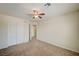 Bedroom featuring neutral carpet, ceiling fan, and a sliding door closet at 8768 Tom Noon Ave # 101, Las Vegas, NV 89178