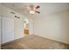 Bedroom with neutral carpeting, ceiling fan and view into the ensuite bathroom at 8768 Tom Noon Ave # 101, Las Vegas, NV 89178