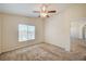 This bedroom has carpet, a window with blinds, and a ceiling fan with a light fixture at 8768 Tom Noon Ave # 101, Las Vegas, NV 89178