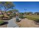 Well-maintained common area with lush green grass, walking path and shaded picnic area at 8768 Tom Noon Ave # 101, Las Vegas, NV 89178