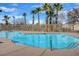Outdoor community pool featuring clear water and a surrounding deck with palm trees at 8768 Tom Noon Ave # 101, Las Vegas, NV 89178